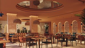 A spacious indoor area with multiple seating arrangements, including tables and chairs, and a central column with a unique design. - Gran Hotel Luna de Cádiz *NEW* (Cádiz)