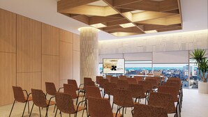 A conference room with a city view, wooden panel walls, and a modern ceiling design. - Gran Hotel Luna de Cádiz *NEW* (Cádiz)