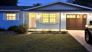 A single-story house with a garage, a driveway, and a lawn. - Cozy 3/2 in downtown quaint Lake Mary, FL with AC and fenced in yard (Lake Mary)
