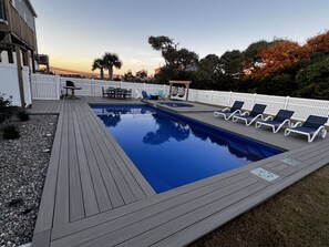 A rectangular swimming pool with a wooden deck, surrounded by a white fence. - Topsail Beach Sunsets, Water views, Pool/Hot tub (N. Topsail Beach)