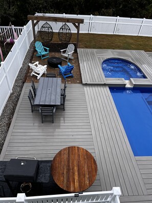 A wooden deck with a hot tub, a pool, and outdoor seating. - Topsail Beach Sunsets, Water views, Pool/Hot tub (N. Topsail Beach)