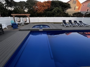 A swimming pool with a wooden deck, lounge chairs, and a hot tub. - Topsail Beach Sunsets, Water views, Pool/Hot tub (N. Topsail Beach)