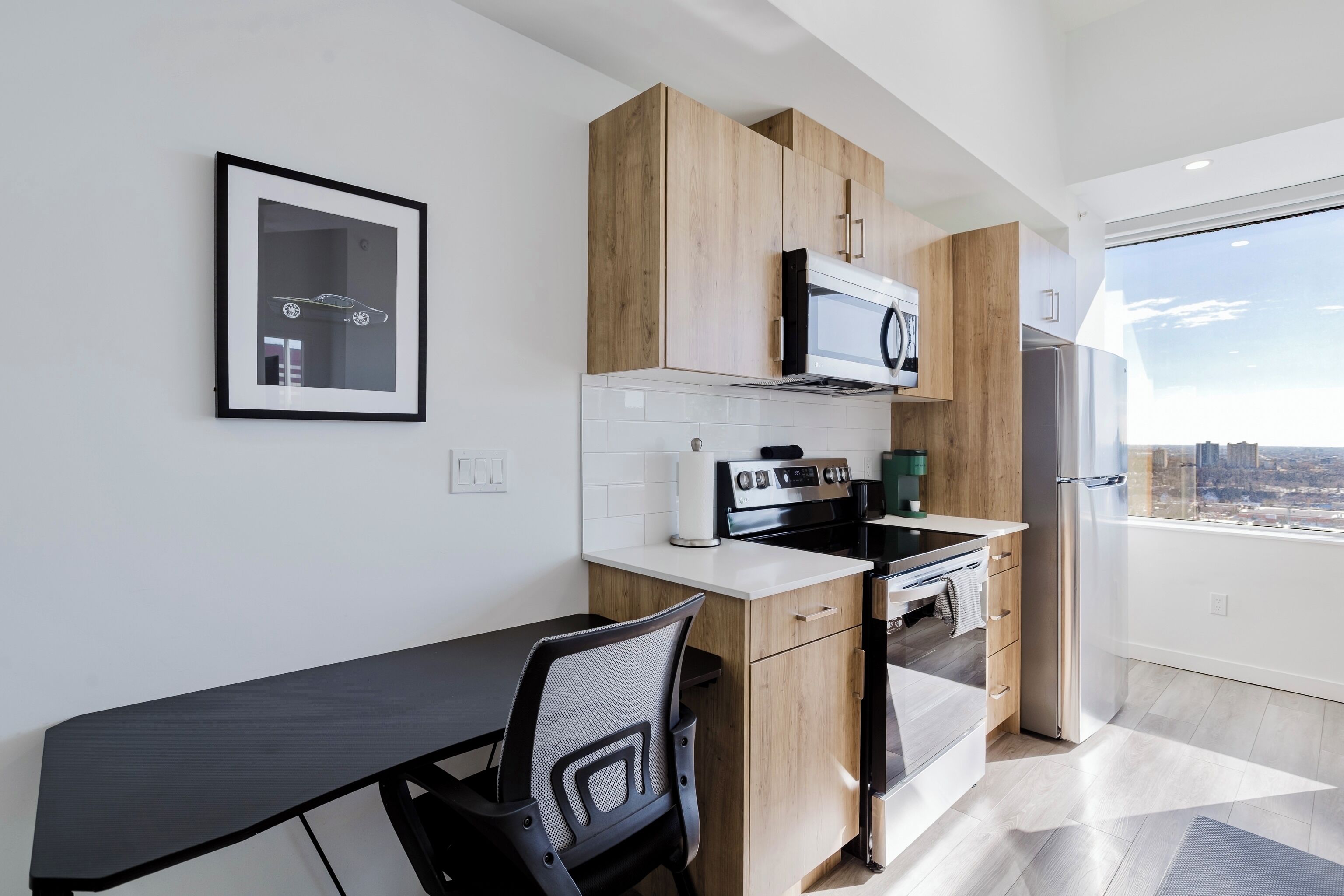 A modern kitchen with wooden cabinets, a microwave, and a stainless steel refrigerator.