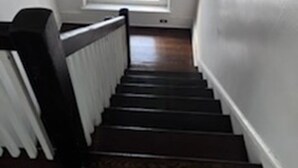 A staircase with a white railing and a window at the top.