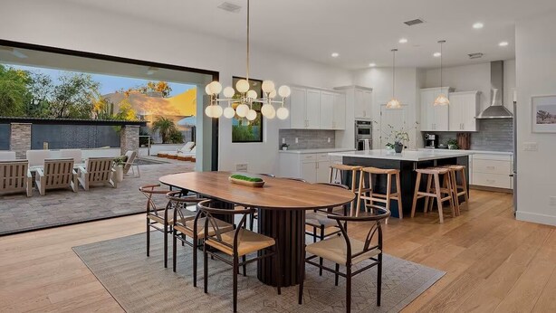 A modern kitchen with a central island, pendant lighting, and a view of the outdoors. - Luxury Resort Oasis : Pool, Pickleball, Sauna, Spa,     Sleeps 14 Comfortably  (Phoenix)