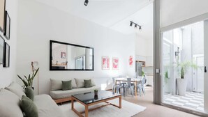 A modern living room with a sofa, coffee table, and a dining area with chairs and a table. - MOT Rentals + SantaFe 5164 - 3 Bd Pool & BBQ Palermo Hollywood (Buenos Aires)