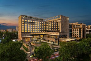 A modern hotel with a prominent 'TAJ' sign, multiple floors, and a rooftop terrace. - Taj Palace, Lucknow (Lucknow)