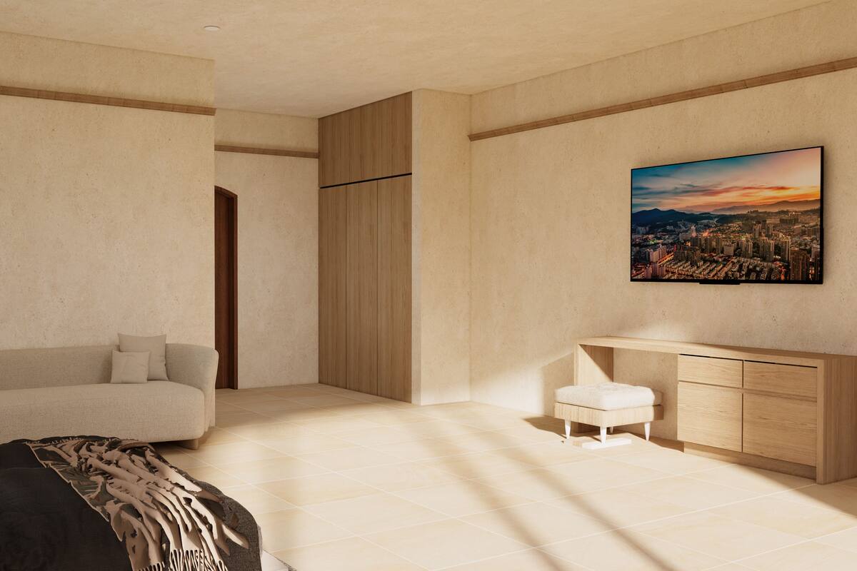 Une chambre moderne avec un canapé, une petite table de chevet, une armoire et un tableau représentant un paysage urbain accroché au mur.