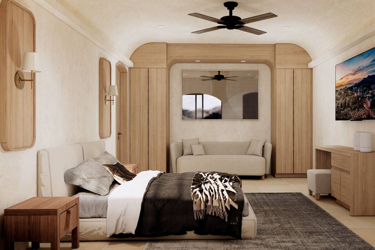 Une chambre à coucher comprenant un lit, une table de chevet, une commode, un ventilateur de plafond, une grande fenêtre et un tableau représentant un paysage urbain.