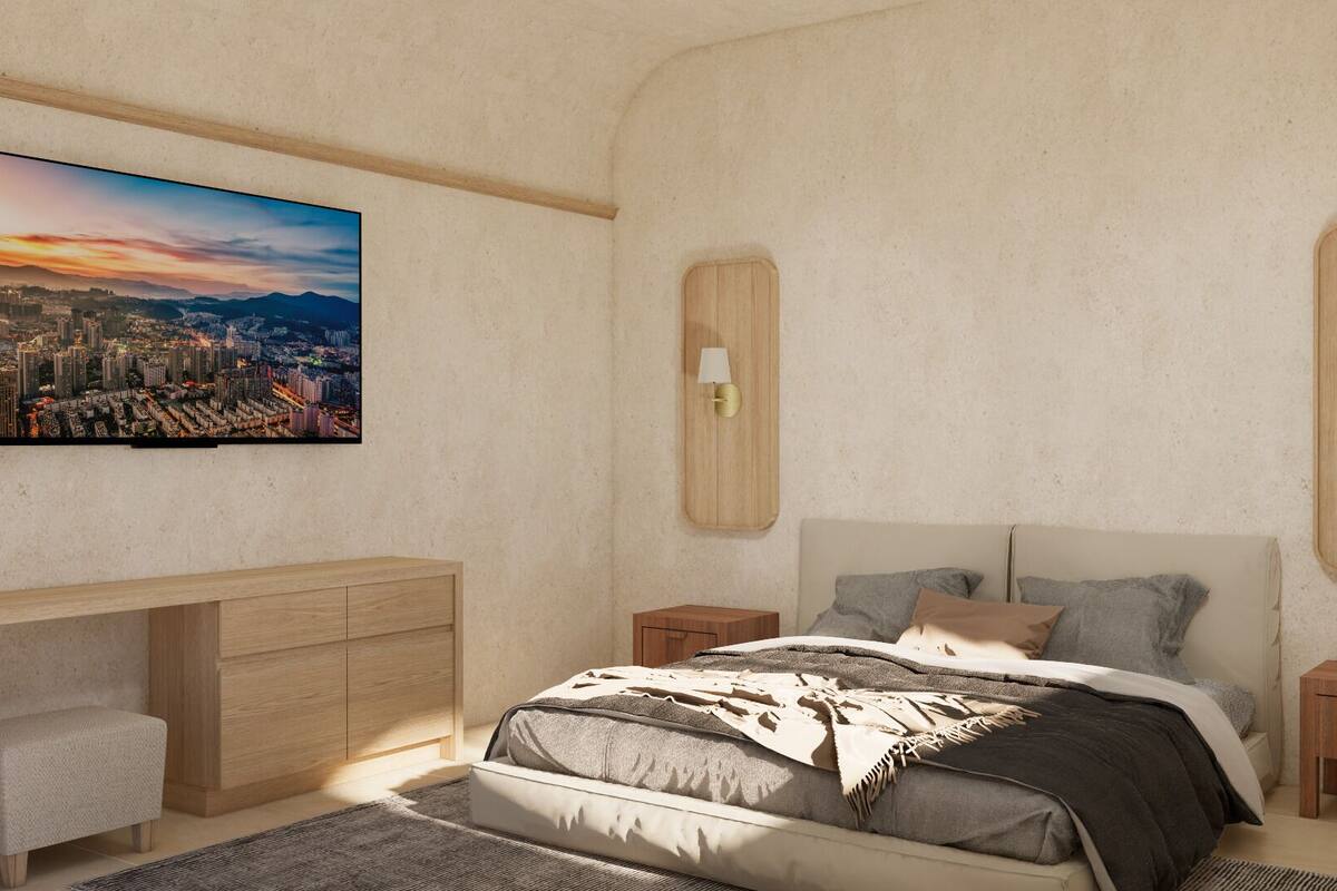 Une chambre à coucher moderne avec un tableau représentant un paysage urbain, un lit avec une literie grise, deux tables de chevet avec des lampes et une table de nuit en bois.