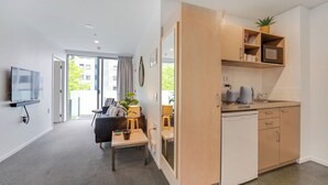 Een modern appartement met keuken, eethoek en woonkamer.