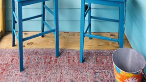 Two blue chairs against a teal wall with a 'CALM STAY' sign. - Lani kai unit 111. Cozy 2bed-2bath condo with beach access. PRIME LOCATION (Gulf Shores)