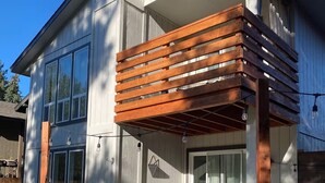 A modern house with a wooden deck and a covered porch. - Clean, quiet, 2-bedroom South Hill rental with a Garage. Conveniently located. (Spokane)