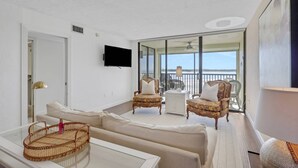 A spacious balcony with a view of the sea, furnished with two chairs and a small table. - Unforgettable Water Views! On the Sand at Island's End! Heated Pool, Free Parking & Beach Gear! (Fort Myers Beach)