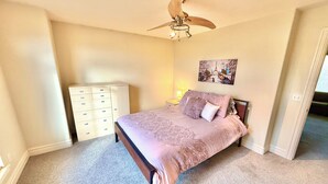 A bedroom with a bed, a ceiling fan, a dresser, and a wall-mounted picture. - Spacious Townhome Near Downtown (Salt Lake City)