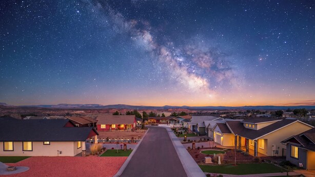 A residential street at dusk with houses on both sides, a clear sky, and a visible Milky Way. - Modern Wine Country Escape in the Verde Valley + Fire Pit + Sleeps 6+ (Cottonwood)