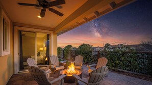 A patio with Adirondack chairs, a fire pit, and a view of the night sky. - Modern Wine Country Escape in the Verde Valley + Fire Pit + Sleeps 6+ (Cottonwood)