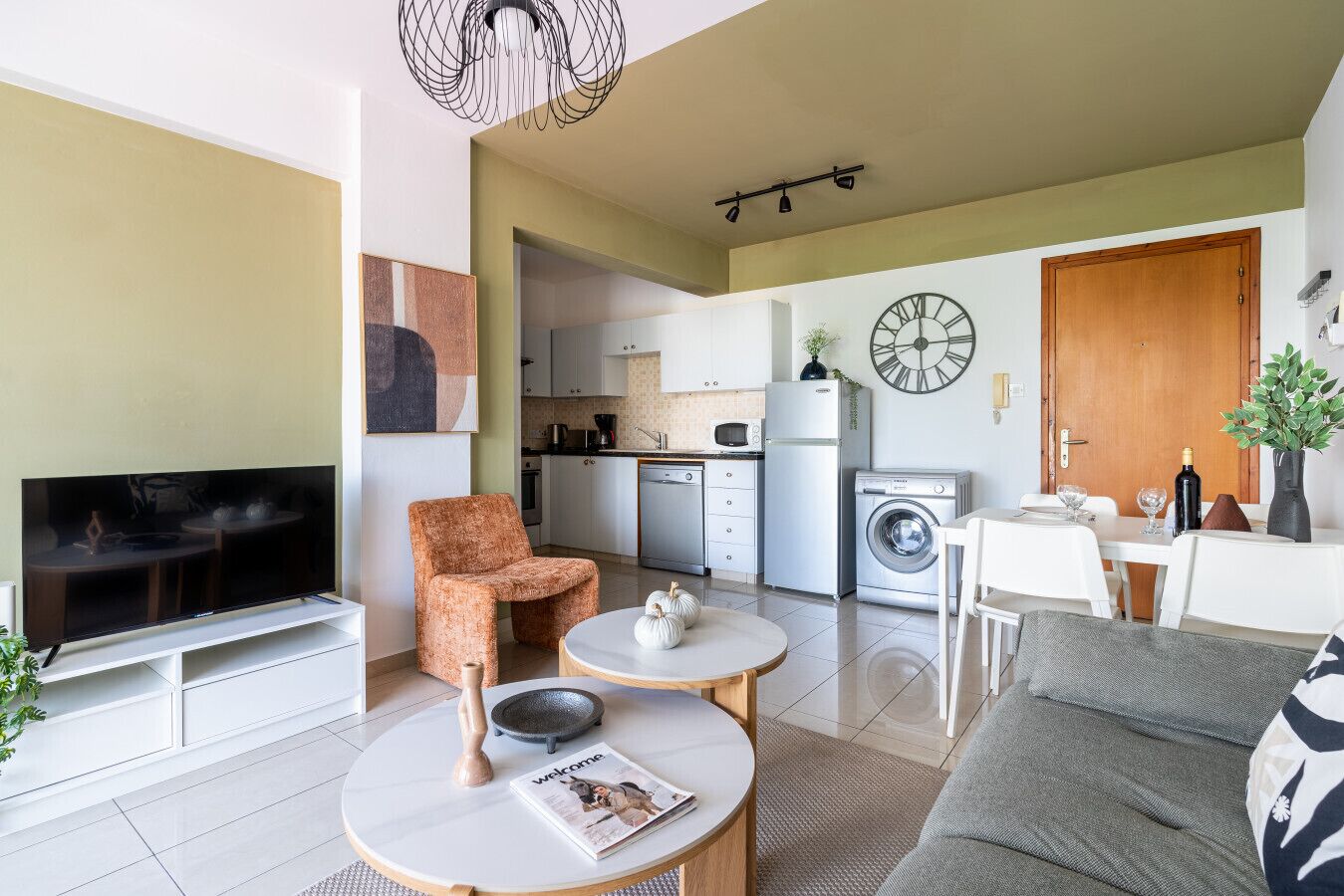 A modern apartment with a living room, kitchen, and dining area.