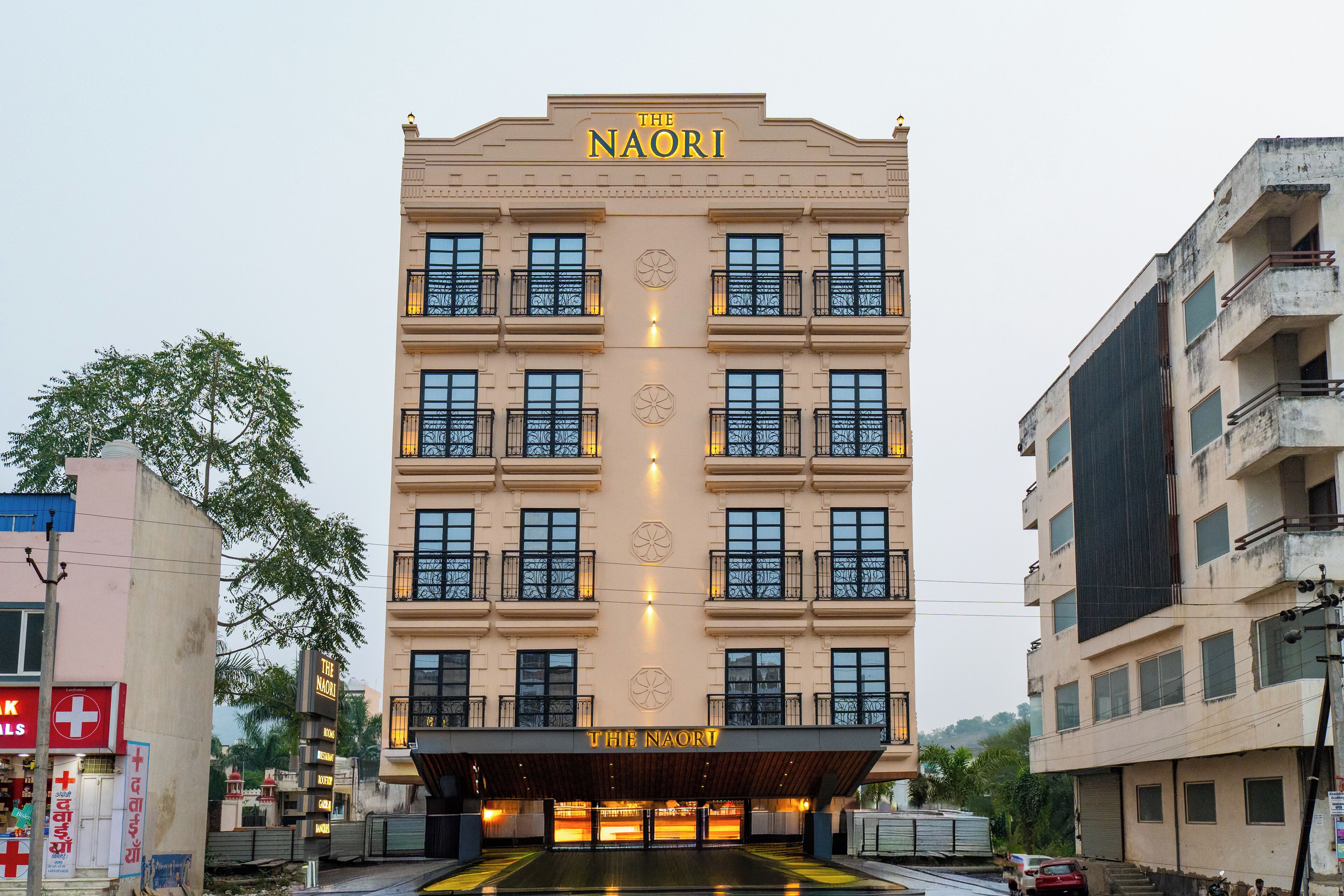Un hotel de varios pisos con un cartel llamativo que dice "The Naori".