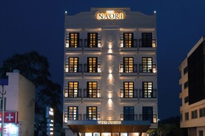 A multi-story hotel with illuminated signage reading "The Naori." - Naori by Alaya Stays (Udaipur)