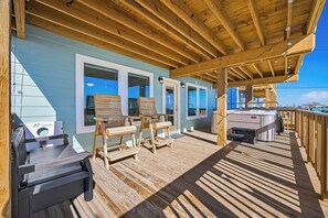 A wooden deck with outdoor seating and a hot tub. - Beachfront Bliss! Brand New Build! Pets! HOT TUB! Affordable! Near Restaurants (Surfside Beach)