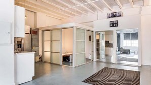 A modern interior with a kitchen, a living area, and a dining space.