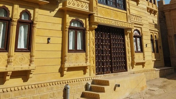 A multi-story building with ornate architectural details, including arched windows and decorative moldings. - Mayra Boutique Casa (Jaisalmer)