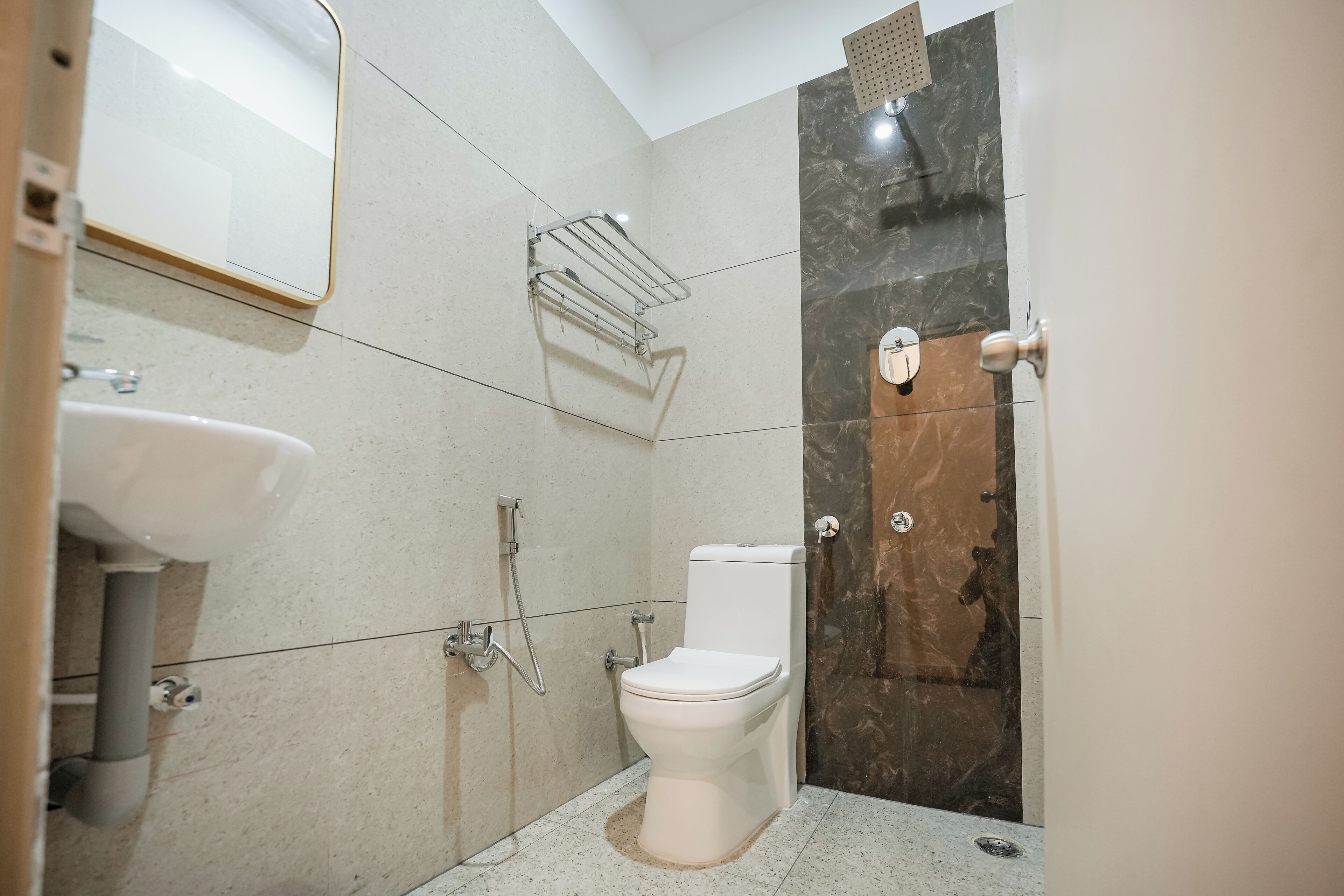A modern bathroom with a toilet, sink, and shower.