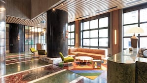A spacious lobby with a marble floor, seating areas, and large windows. - The Queensbridge Skyline Suite, Heated Pool, Gym, Sauna, Steam next to Casino (Southbank)