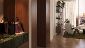 A modern living room with a wooden floor, a striped rug, a sofa, a coffee table, and a bookshelf with decorative items. - The Queensbridge Skyline Suite, Heated Pool, Gym, Sauna, Steam next to Casino (Southbank)