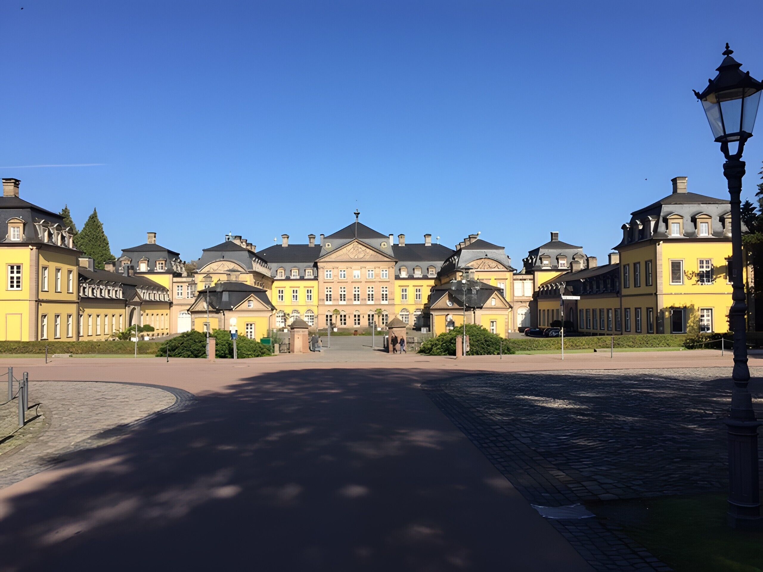 A large, historic building with multiple wings and a central courtyard.