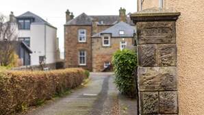 A narrow street with stone buildings, one labeled "ROCKLANDS". - Rocklands (No 11) | Elie (Elie)