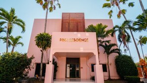 A building with a sign reading 'PINK RESIDENCE' and a modern architectural design. - Pink Residence Chalong (Rawai)