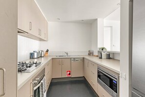 Fridge, microwave, oven, stovetop - 2-Bed Harbourside Home with Views in Fab Location (McMahons Point)