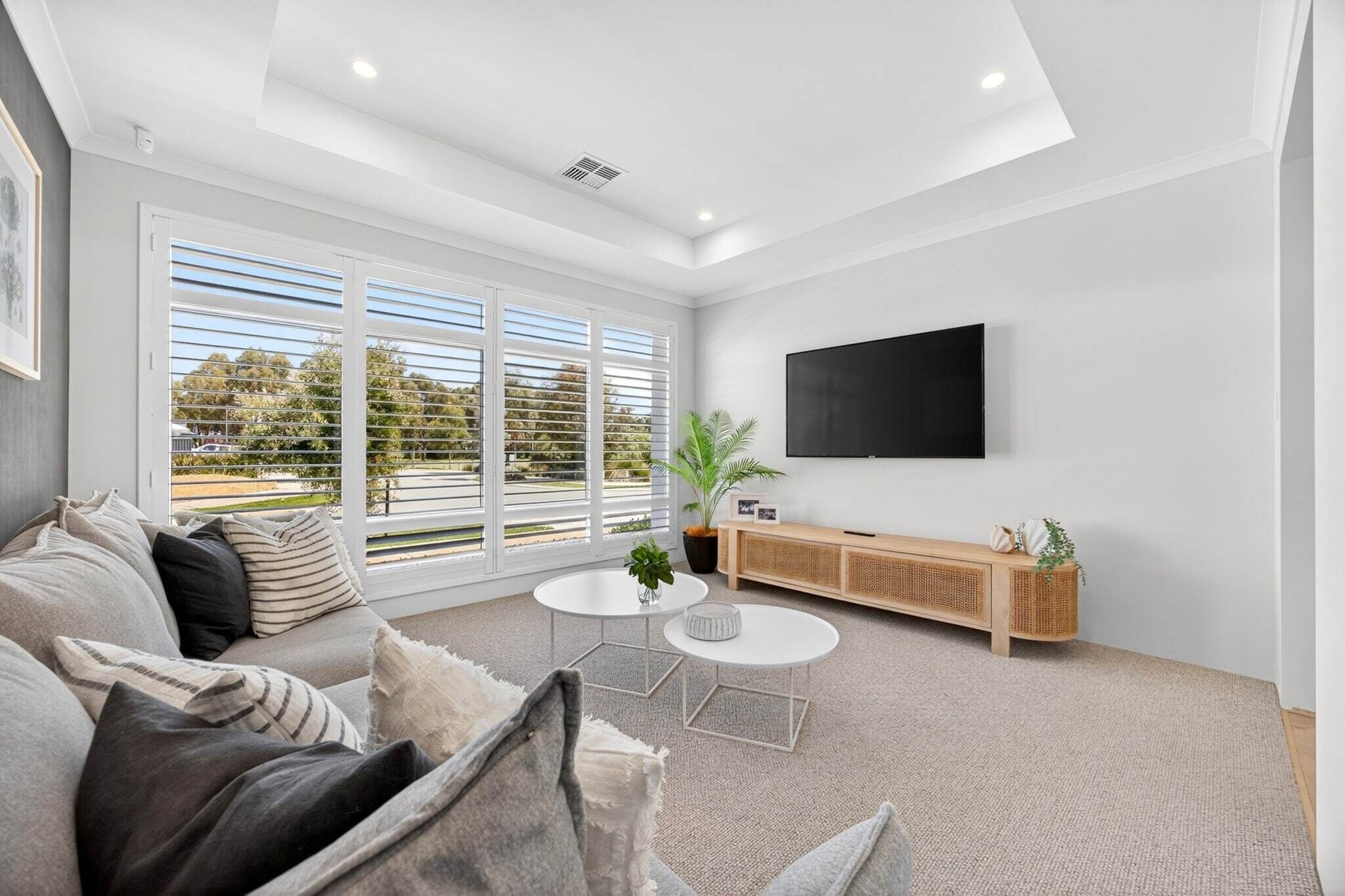 A modern living room with a sofa, coffee table, and TV.