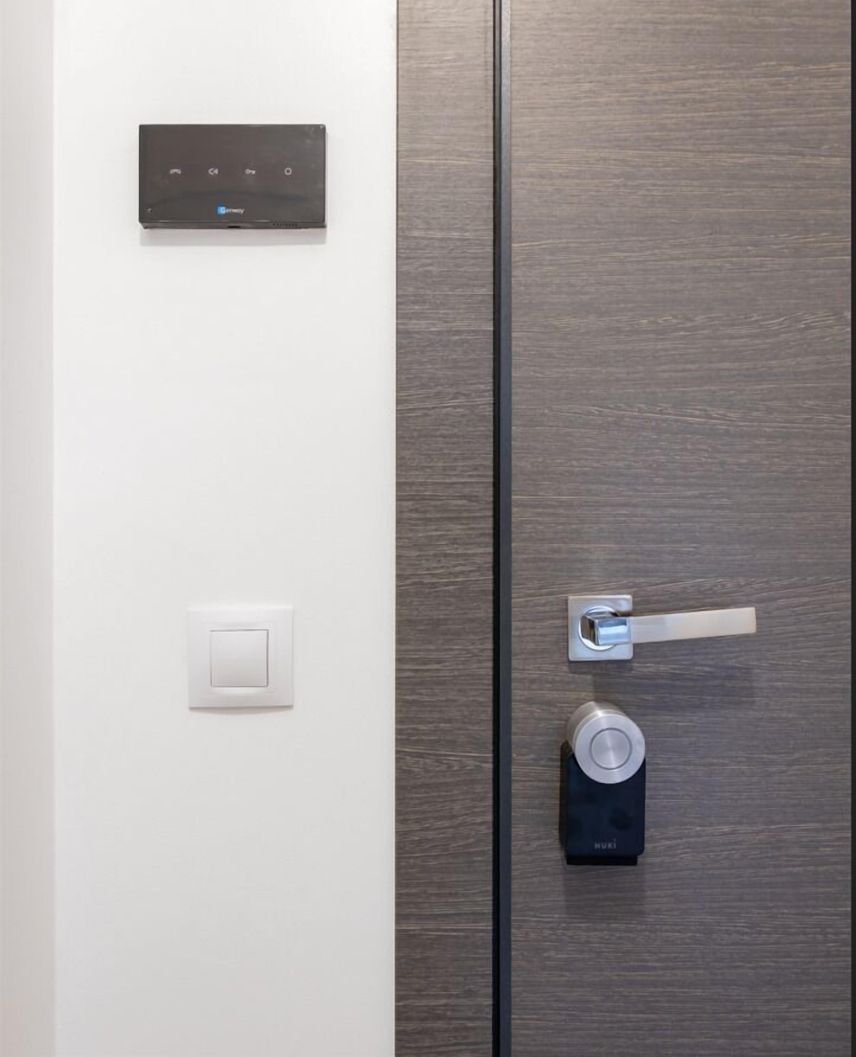 A modern door with a digital lock and a keyhole.