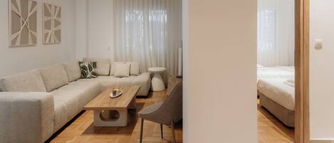 Deluxe Apartment, Kitchen | Living area | 50-inch TV with cable channels