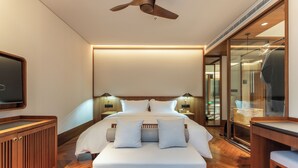 A modern hotel room with a large bed, wooden headboard, bedside lamps, a flat-screen TV, and a wooden desk with a chair. - Mengxi Bieyuan Forest Resort Hotel (Huangshan)