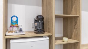 A kitchen area with a Bosch coffee maker, a white refrigerator, and a wooden shelf with a candle. -  'Gran Canaria' with Balcony and Wi-Fi (Las Palmas de Gran Canaria)