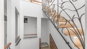 A staircase with a metal railing, wooden steps, and a patterned wall. -  'Gran Canaria' with Balcony and Wi-Fi (Las Palmas de Gran Canaria)