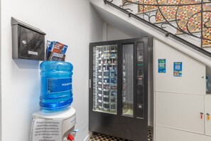 A water dispenser, a recycling bin, and a vending machine in a hallway. - 'La Gomera' with Wi-Fi and Air Conditioning (Las Palmas de Gran Canaria)