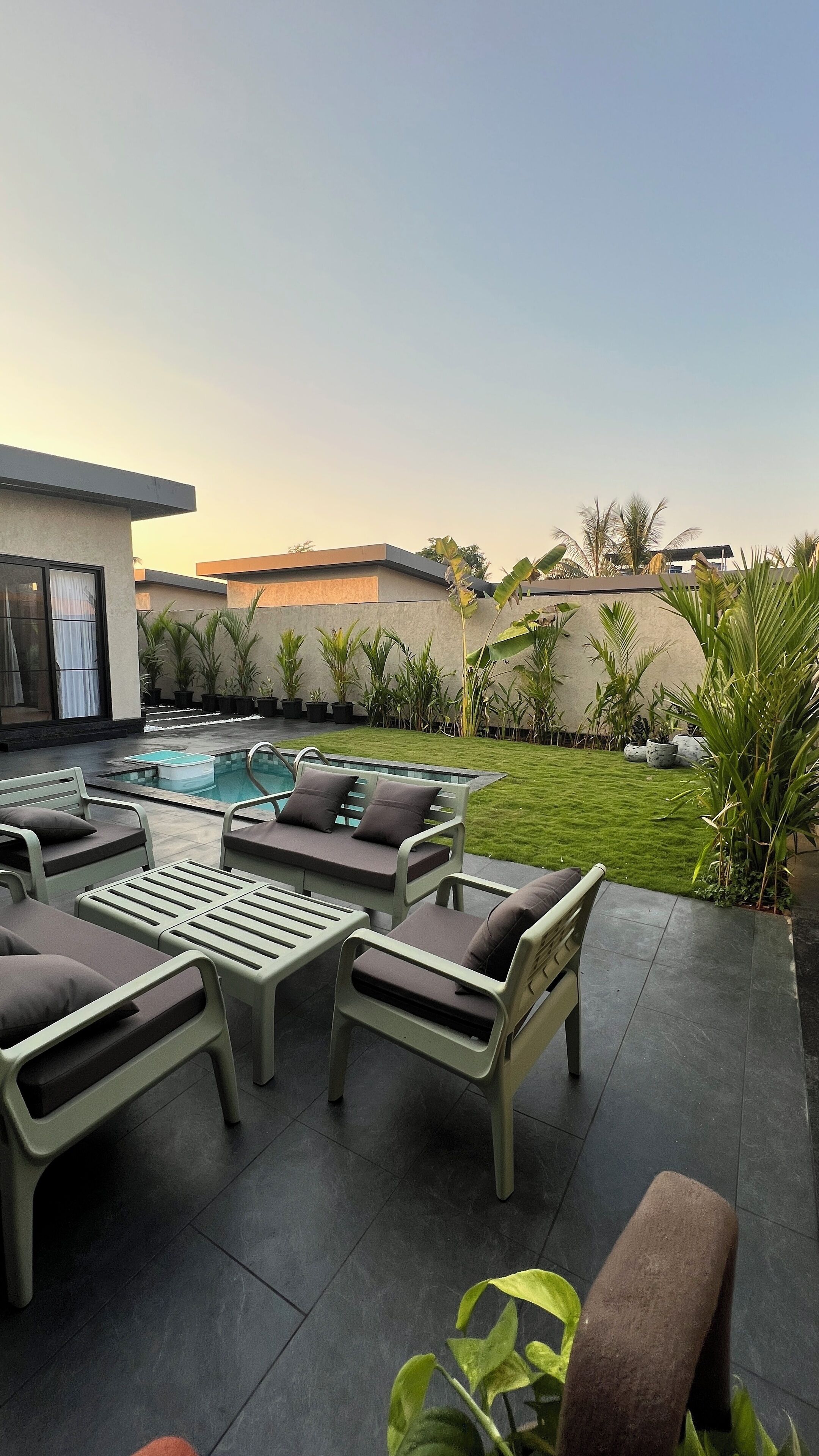 A poolside area with lounge chairs and a small pool.