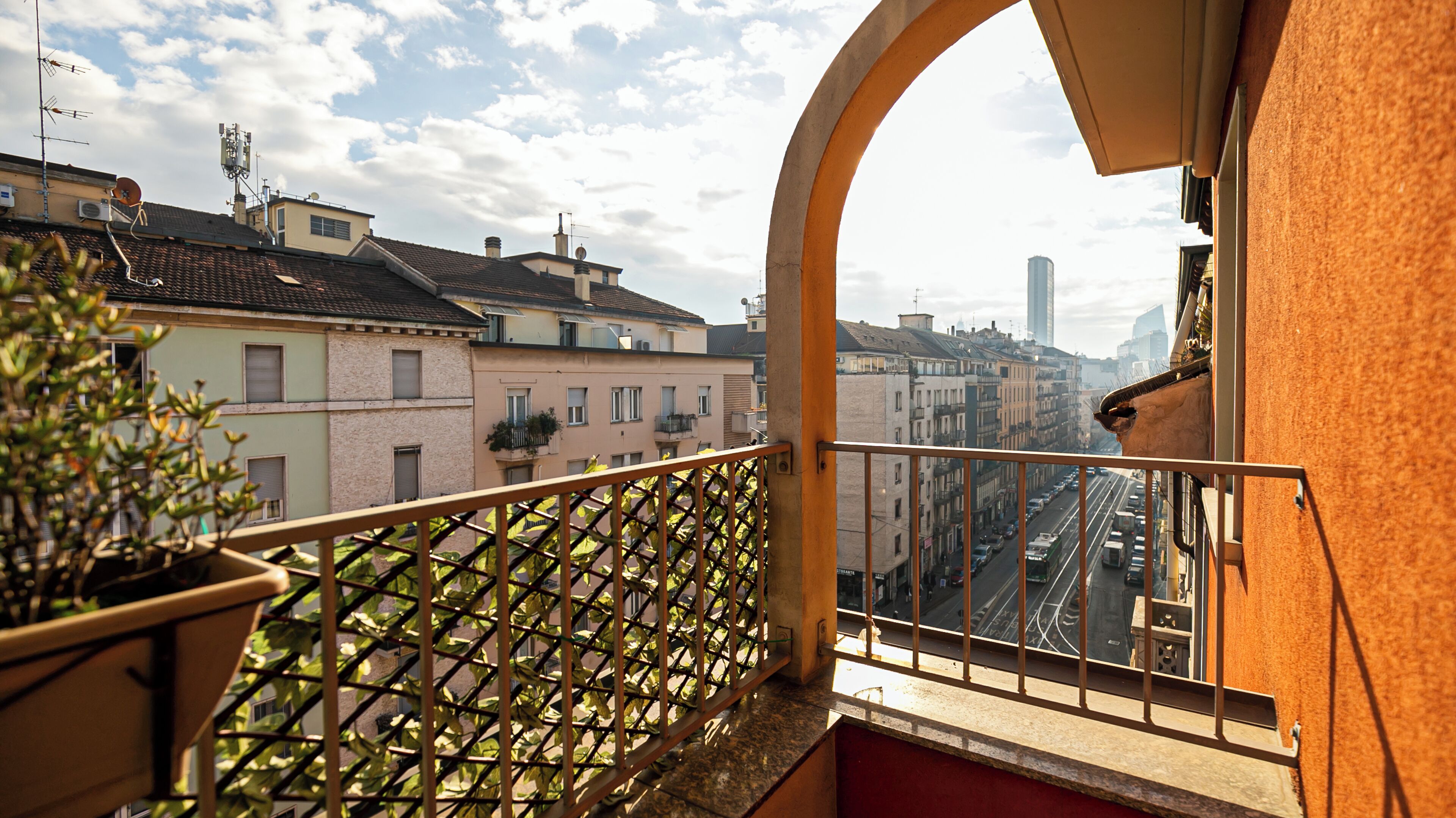 A balcony with a view of a city street and buildings.