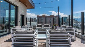 A rooftop terrace with outdoor seating, a city view, and a clear sky. - 8thFloor!|CityView|HotTub|Pool|Gym|Parking|KingBed (Salt Lake City)