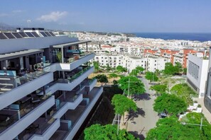 A modern building with multiple balconies overlooking a coastal cityscape. - Lme133a- Stunning Flat Close to Beach in Estepona (Estepona)