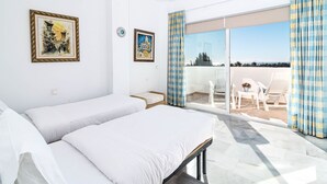 A hotel room with two beds, a balcony with a view, and two framed artworks on the wall. - Rg325 - Great 2 Bed Apt, Close to Puerto Banus (Marbella)