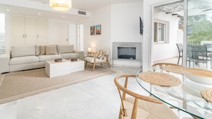 A modern living room with a sofa, coffee table, and glass dining table with woven placemats. - Lnm530 - Great Location With Private Roof Terrace (Marbella)