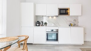 A modern kitchen with white cabinetry, a built-in microwave, and an oven. - Lnm530 - Great Location With Private Roof Terrace (Marbella)