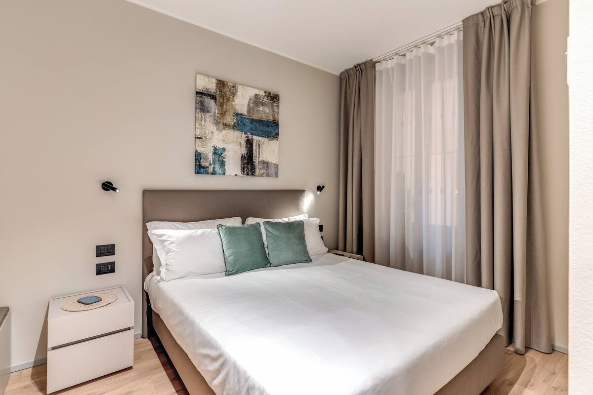 Laptop workspace, iron/ironing board, bed sheets
