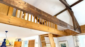 A room with exposed wooden beams, a slanted ceiling, and a view of the outside. - The Cabin - Hidden Retreat in the Heart of Salcombe (Salcombe)
